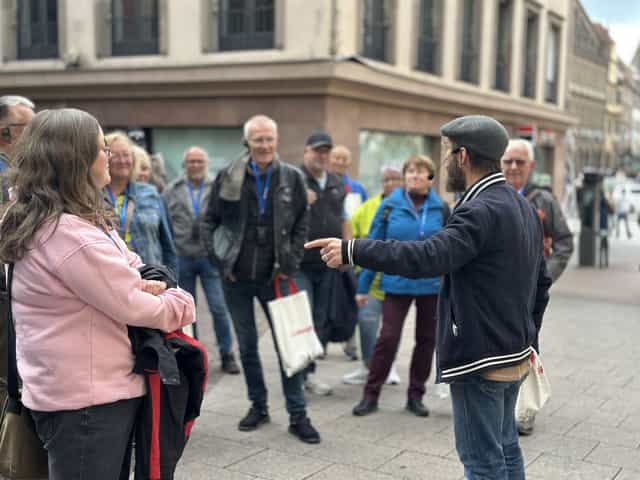 VéloRouge guide introducing Strasbourg to a group wearing tour headsets