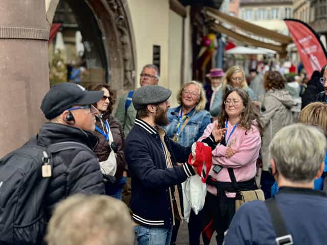 Guide talking with guests during a Strasbourg walking tour